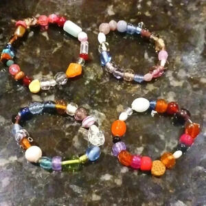 A set of four elastic beaded bracelets..perfect for anyone..size S in Adults